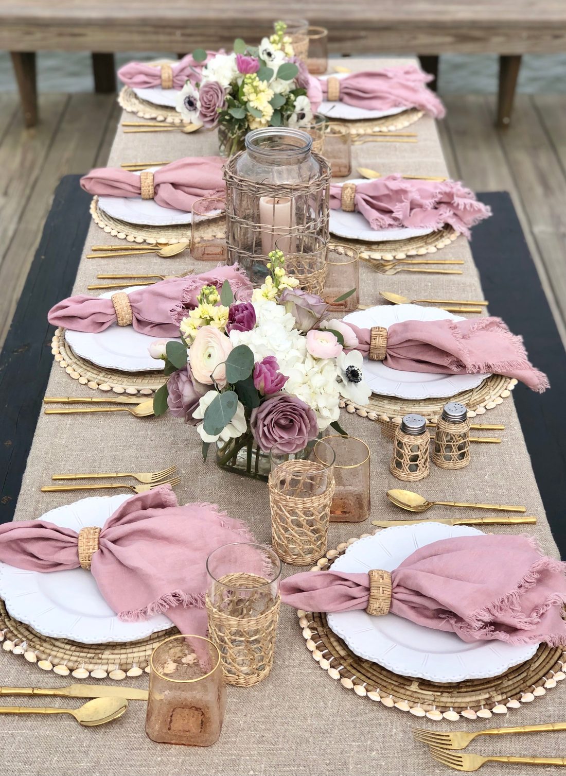 Elegant Shabbat table setting with flowers and gold accents